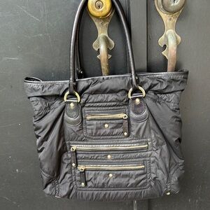 Tod’s black nylon & leather multi zipper pocket gold hardware shoulder bag.